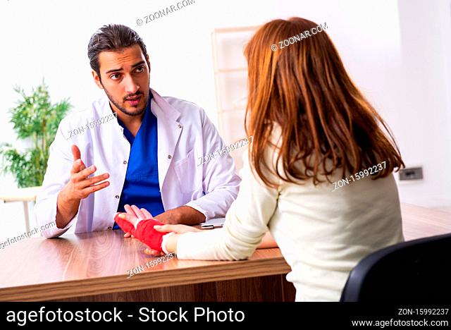 Young hand injured woman visiting doctor traumatologist
