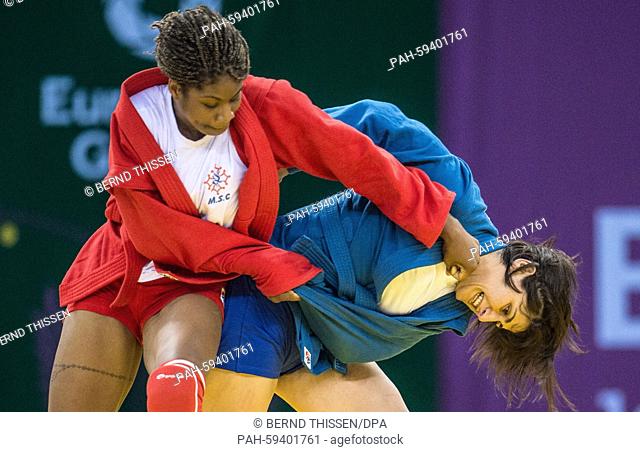 Celine Conde of France (red) fights against Tea Sukhitashvili (blue) of Georgia during the Women's -68 kg 1/8 final competition in Sambo at the Baku 2015...