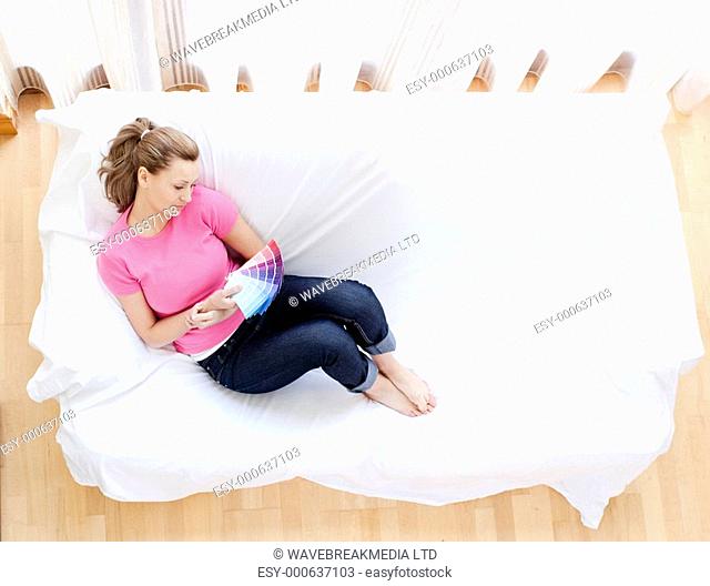 Beautiful woman choosing colors to decorate her house in the living-room