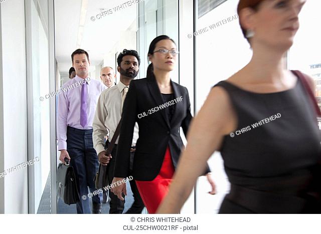 Business people rushing past camera