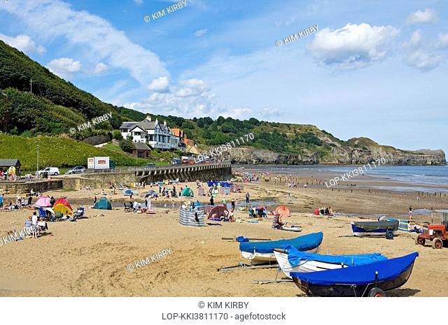 England, North Yorkshire, Sandsend. People enjoying the summer sunshine on Sandsend beach near Whitby