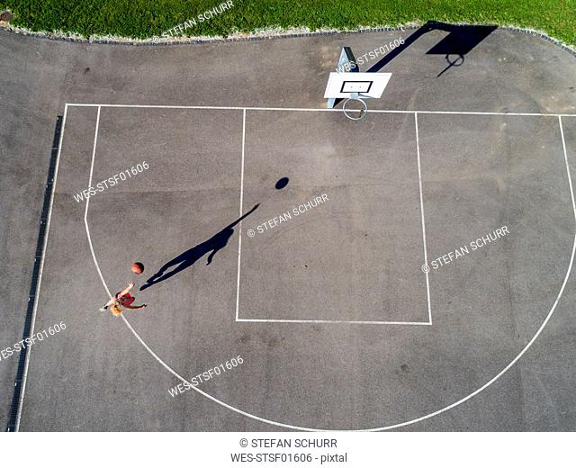 Aerial view of young woman playing basketball