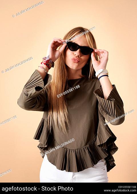 Pretty young woman with cheerful fitness, sunglasses and sticking out snouts