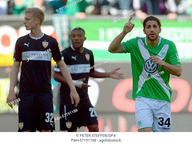 Wolfsburg's Ricardo Rodriguez (r) celebrates his goal at 1:0. Stuttgart's Timo Baumgartl (l) and Geoffroy Serey look on during the German Bundesliga soccer...