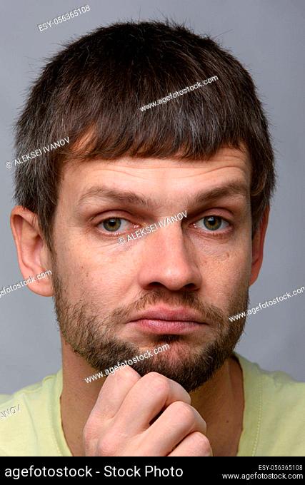 Closeup portrait of a skeptical man of European appearance