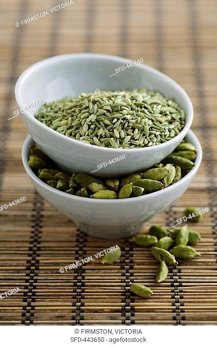 Fennel seeds and cardamom pods in bowls