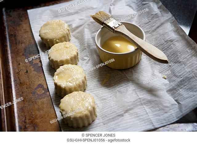 Brushing Homemade Country Biscuits with Butter