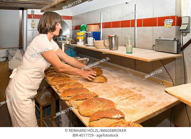 Farmer making bread in her own bakery on the farm, finished breads, Tyrol, Austria