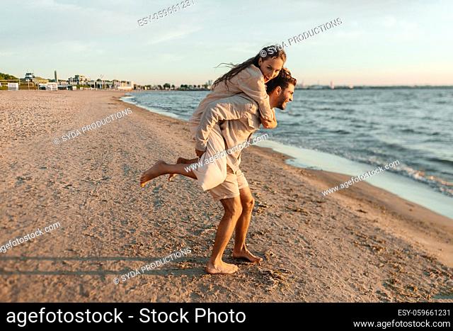 happy couple having fun on summer beach