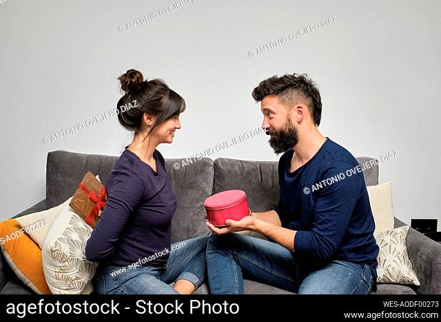 Adult couple exchanging gifts on Valentines Day