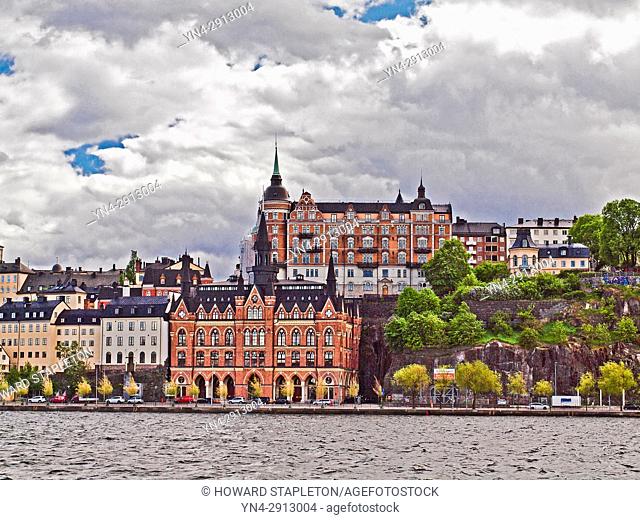 Apartment buildings in Stockholm, Sweden. The red building atop the hill known as Laurinska Huset is a 6-story building with towers and was built in 1892