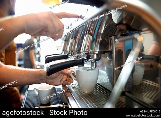 Hands of barista making coffee with espresso machine
