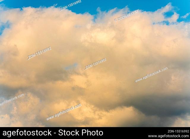 Summer clouds floating across sunny blue sky to change weather. Atmospheric and optical dispersion, soft focus, motion blur clouds