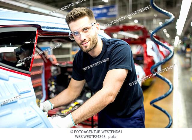 Portrait of confident man working in modern car factory
