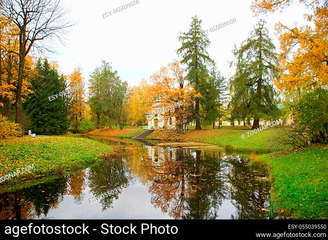 Morning walk in Catherine Park in Tsarskoye Selo, autumn landscape and a creaky arbor on the shore of the pond