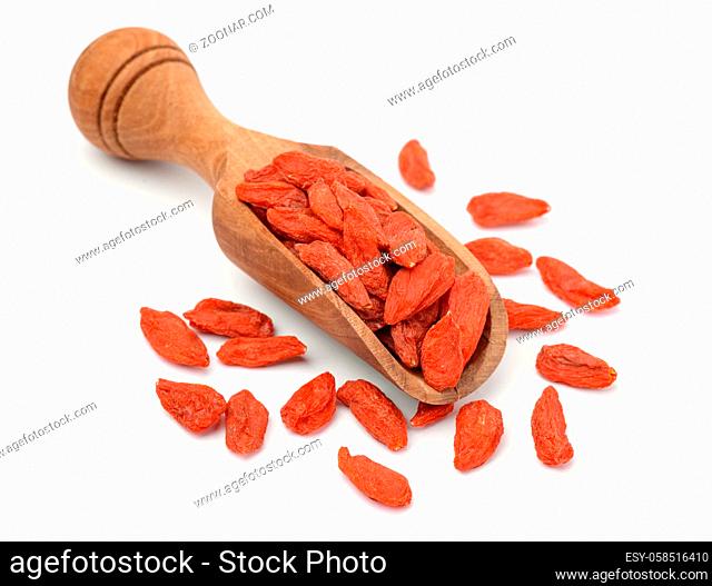 Dried goji berries in wooden scoop isolated on white