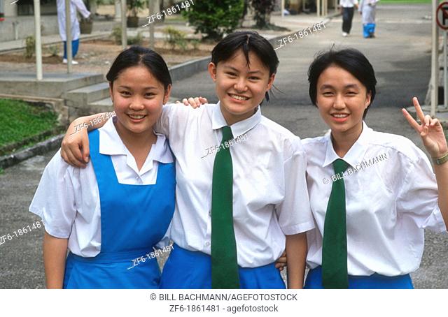 Malaysia, Kuala Lumpur, Portrait of school girls on street