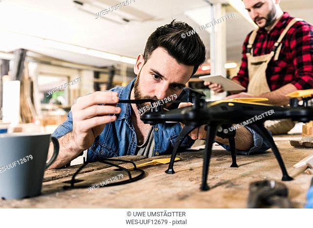 Man working on drone in workshop
