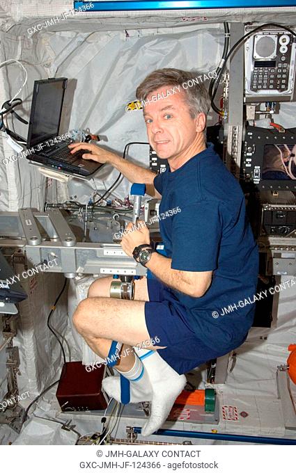 Canadian Space Agency astronaut Robert Thirsk, Expedition 20 flight engineer, works with the Space Linear Acceleration Mass Measurement Device (SLAMMD) in the...