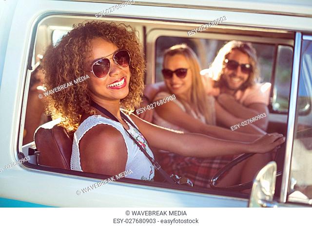 Happy woman driving a campervan