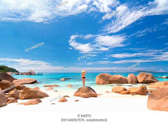 Woman enjoying Anse Lazio picture perfect beach on Praslin Island, Seychelles