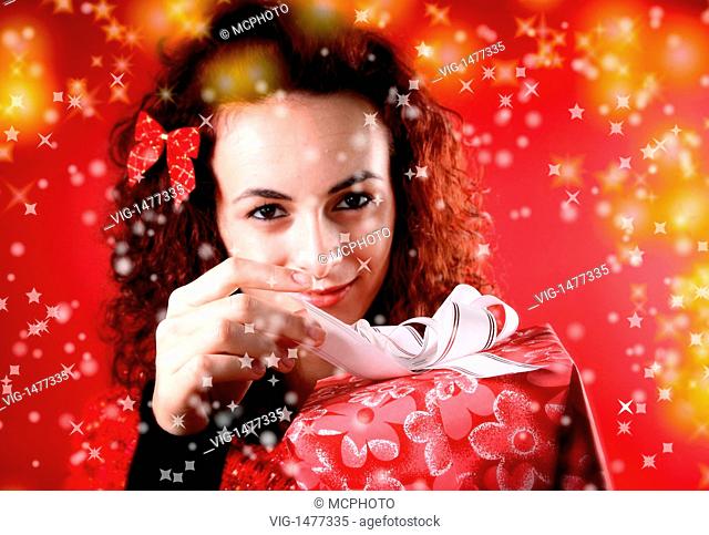 woman with a gift in her hands and snowflakes - 02/11/2007