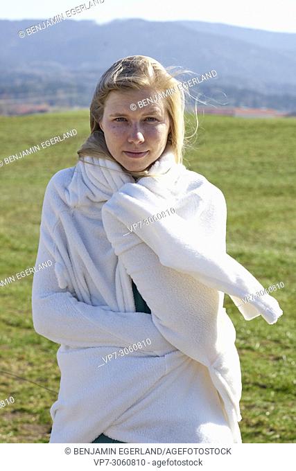 Portrait of woman in nature wearing a white bathrobe. Waakirchen, Bavaria, Germany