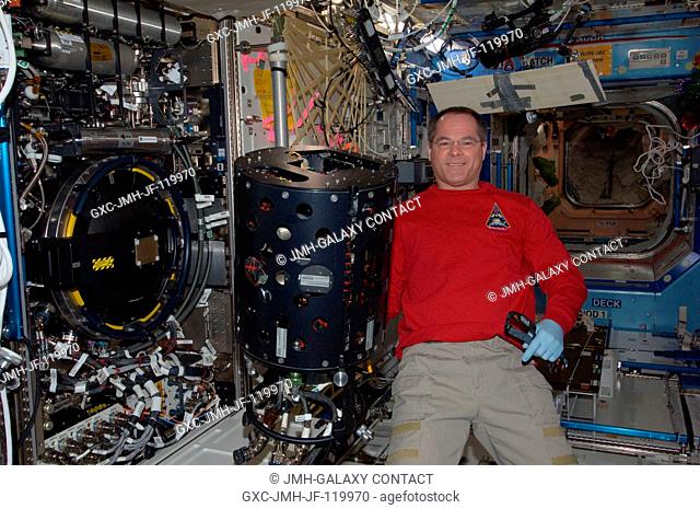 NASA astronaut Kevin Ford, Expedition 34 commander, performs in-flight maintenance on the Combustion Integrated Rack (CIR) Multi-user Droplet Combustion...