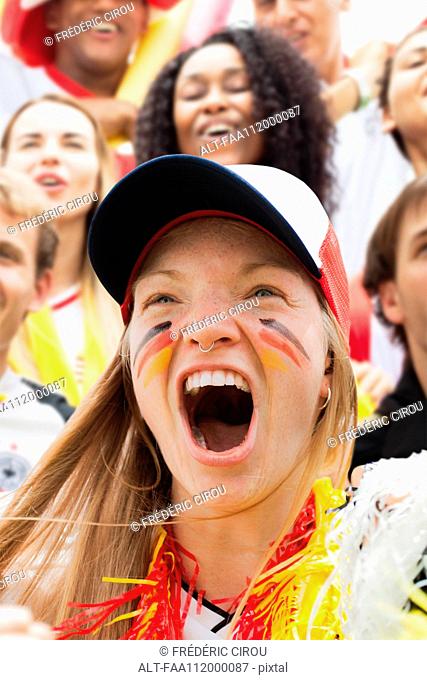 German football fan cheering at match, portrait