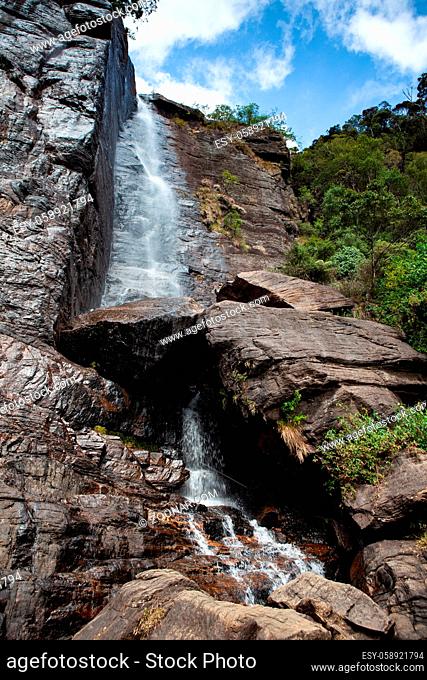 Lovers leap waterfall in Nuwara Eliya, Sri Lanka. Lovers leap is an impressive waterfall known for its romantic folklore situated on a rocky cliff above the tea...