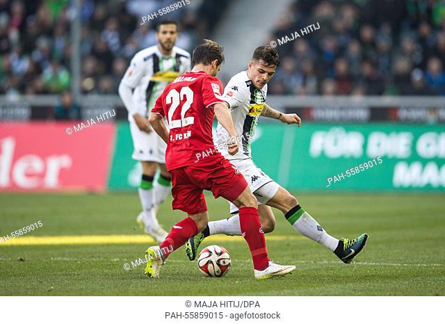 Koeln's Daniel Halfar and Moenchengladbach's Filip Daems (R) vie for the ball during the German Bundesliga soccer match between Borussia Moenchengladbach and 1