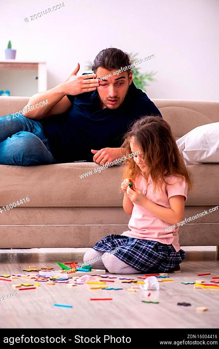 Young father and little girl at home