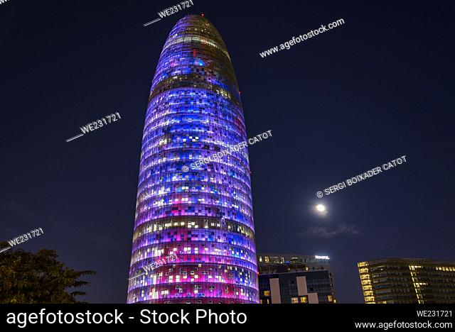 Torre Glòries (formerly Agbar) illuminated at night during the Llum BCN 2023 festival and the Full Moon (Barcelona, Catalonia, Spain)