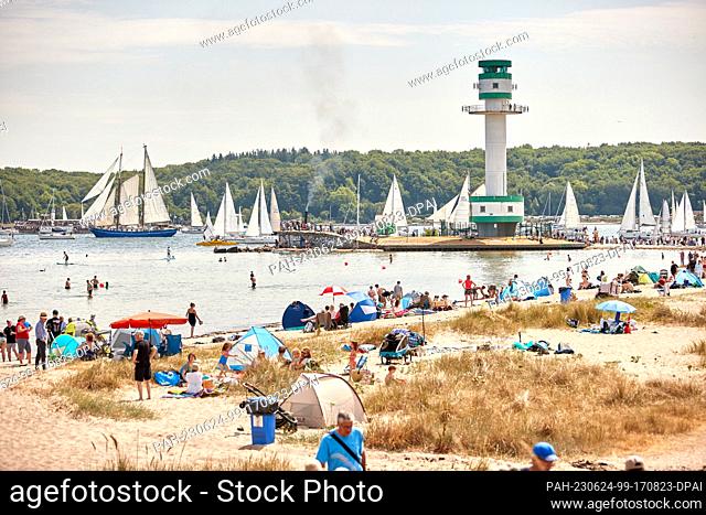 24 June 2023, Schleswig-Holstein, Kiel: Ships, boats, sailors and traditional sailing vessels take part in the Kieler Woche windjammer parade on the fjord at...