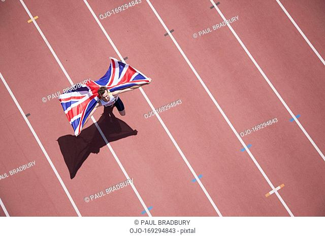 Runner celebrating with British flag on track