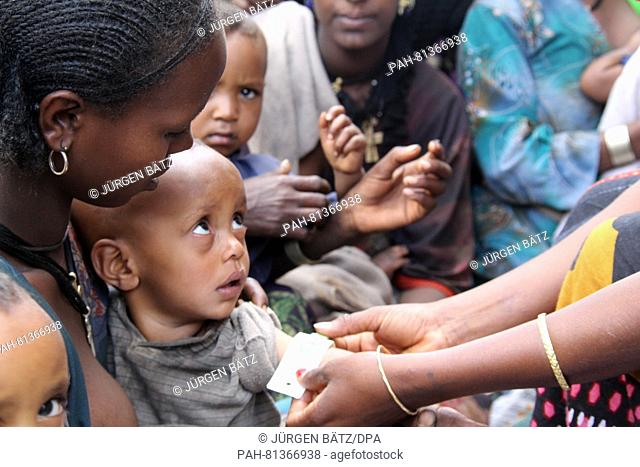 An employee of a health centre measures the arm circumfence of a small child in order to determine if it is malnutritioned in the North Ethiopian village of...