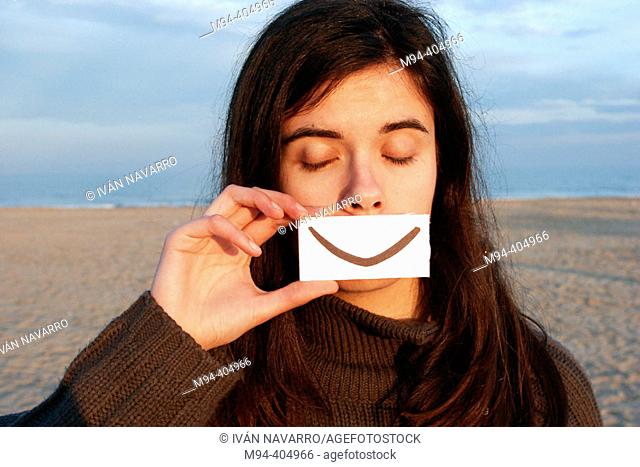 Girl with fake smile and eyes closed