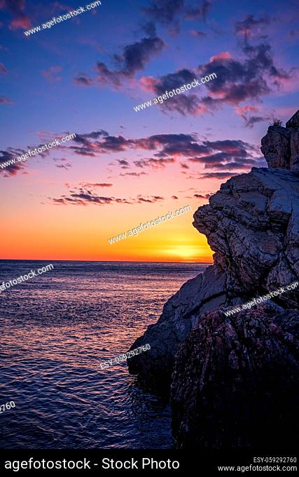 Beautiful sunset over the cliffs in Petrovac coast, Montenegro