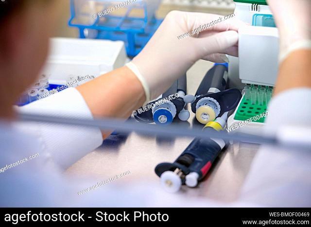 Male scientist conducting research on COVID-19 vaccination in laboratory