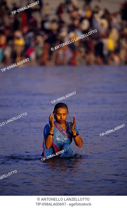 India, Uttar Pradesh, Allahabad Prayag, Kumbh Mela holy Festival. Woman bathing in Sangam river