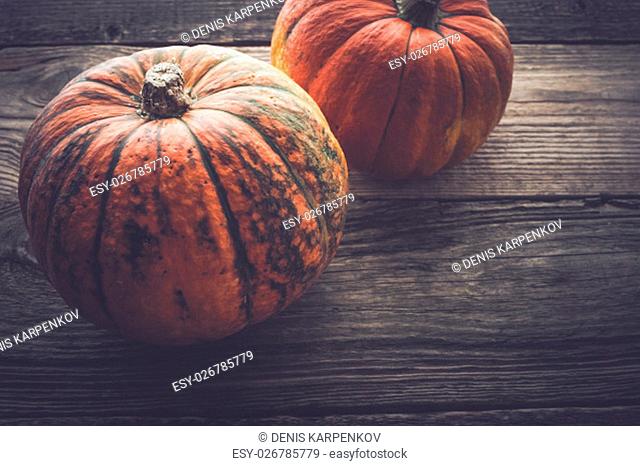 Two pumpkins on the wooden table horizontal