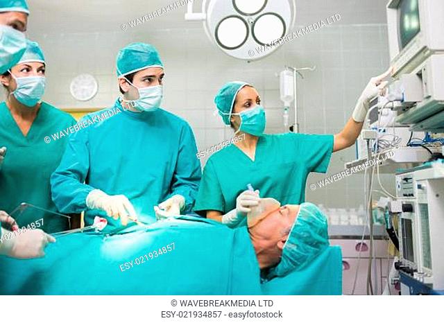 Surgical team looking at a monitor in an operating theatre