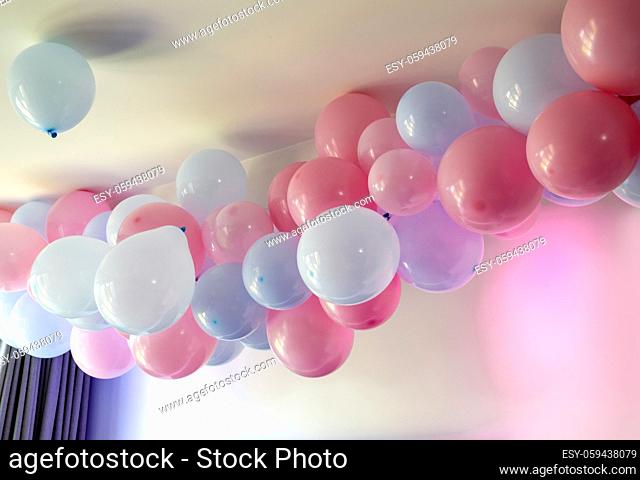 gender reveal party blue and pink balloons in living room on white wall definition of a boy or girl, gathering party party decoration baby concept