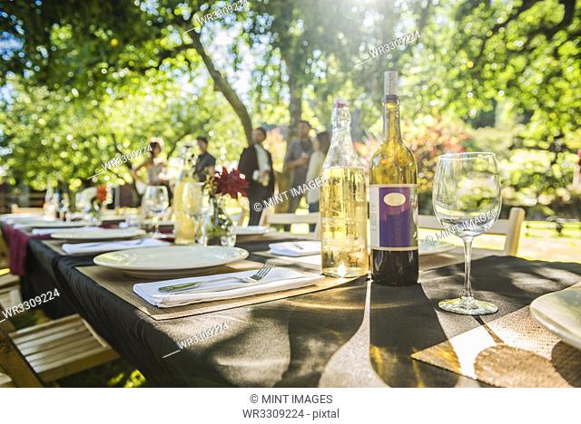 Wine bottles on table at party outdoors