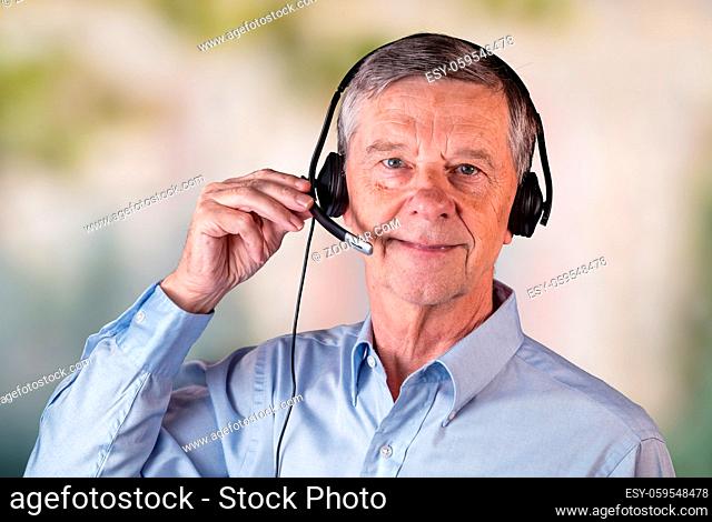 Senior caucasian man using headset to talk to customers or team in work from home