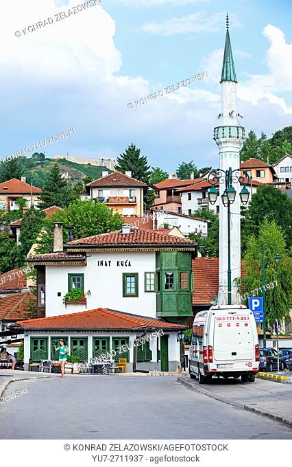 traditional Bosnian restaurant Inat kuca (House of Spite) and Hadzijska mosque minaret, Old Town of Sarajevo