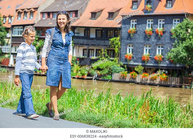 Tourists. Beautiful mother and daughter walking in europe city