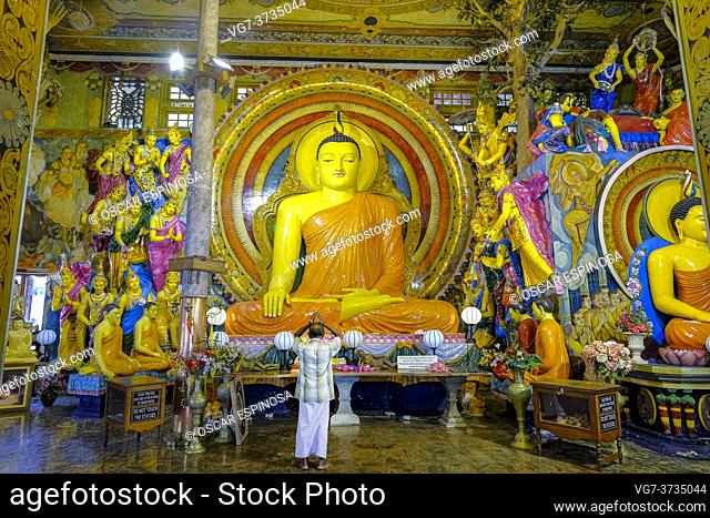 Colombo, Sri Lanka - February 2020: A man praying in the Gangaramaya Temple on February 3, 2020 in Colombo, Sri Lanka