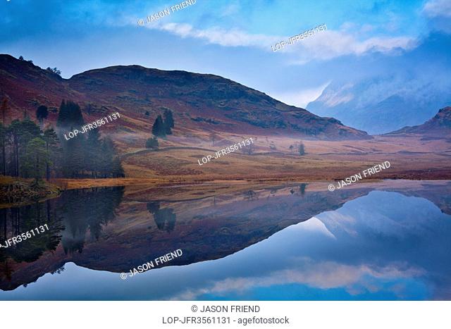 England, Cumbria, Blea Tarn. A misty dawn at Blea Tarn near Great Langdale in the Lake District