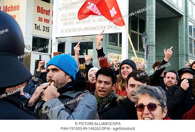 03 October 2019, Berlin: People protest at Checkpoint Charlie against a demonstration of right-wing populists on German Unity Day